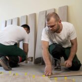 full-shot-workers-tiling-floor-indoors